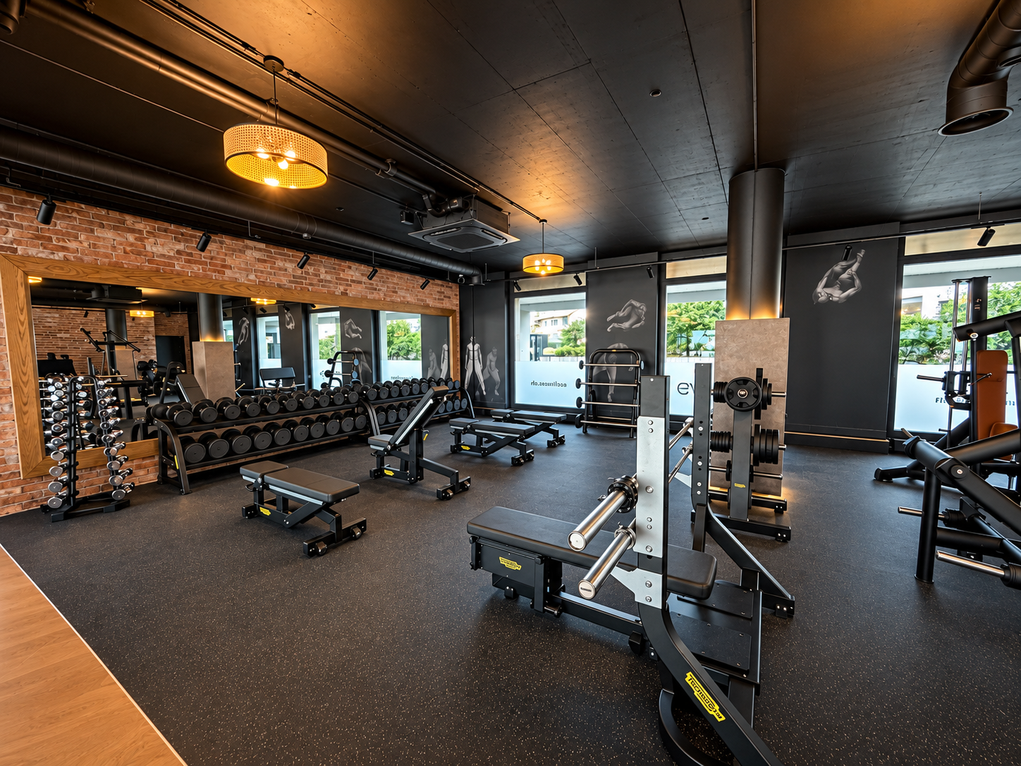Free weights and strength training area with dumbbells and benches at EVO Zurich Dubendorf.