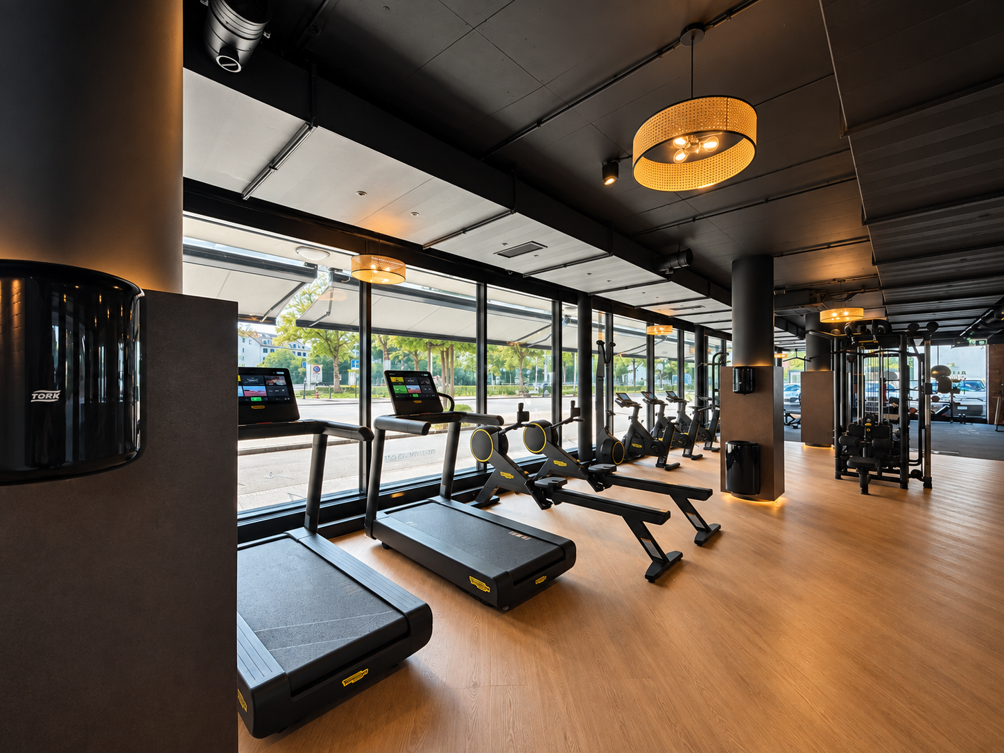 Bright cardio area with treadmills, rowing machines and exercise bikes at EVO Zurich Dubendorf.